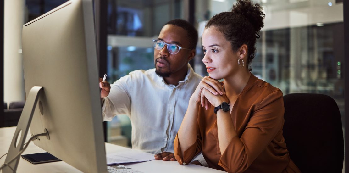 Two colleagues working together to review a HR process