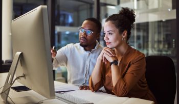 Two colleagues working together to review a HR process