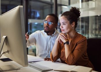 Two colleagues working together to review a HR process